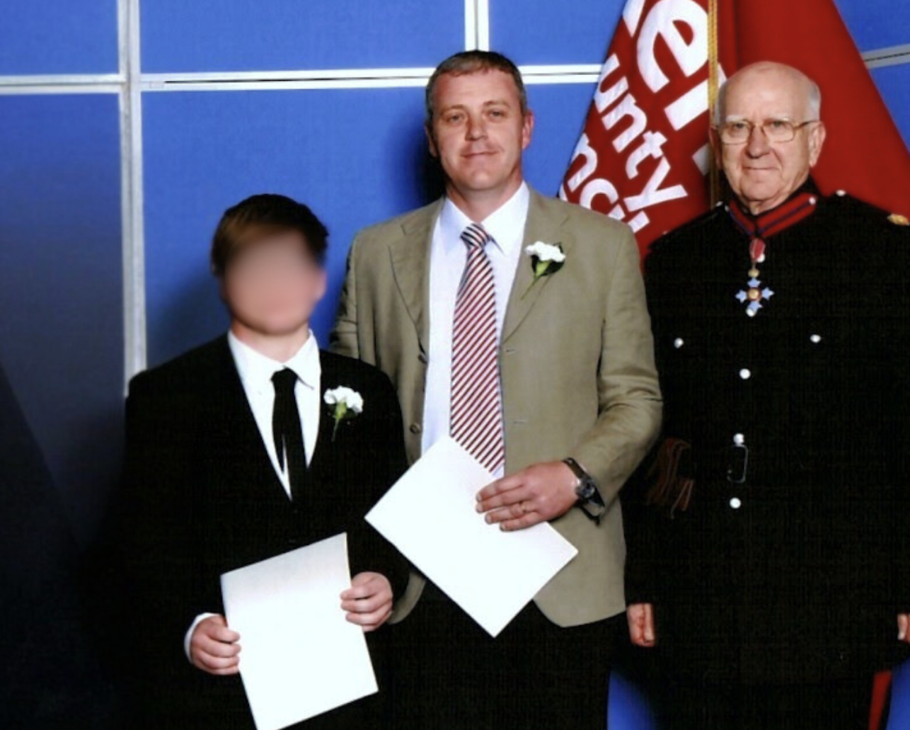 Craig, his son, and Sir Robert Worcester during Craig's British citizenship ceremony, with Sir Robert Worcester officiating the event.